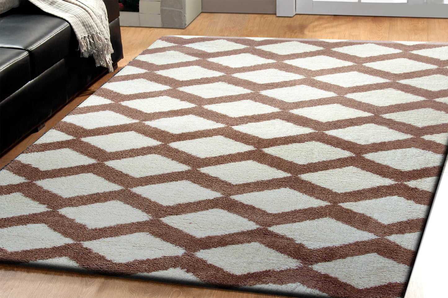 A rectangular rug with a contemporary geometric pattern in brown and white shades, featuring a plush microfiber pile in living room.