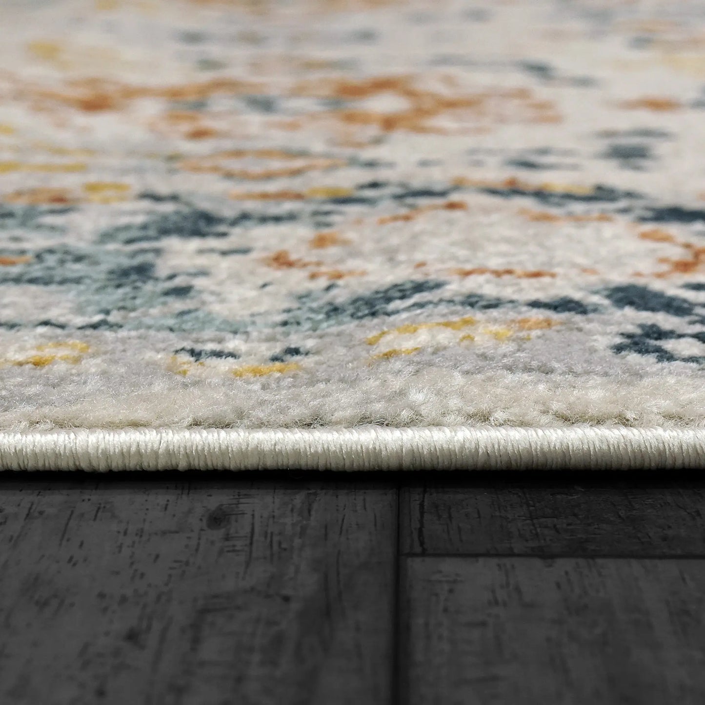 A Zahara rectangular traditional wool runner with a floral pattern in shades of beige, brown, gold, and gray.